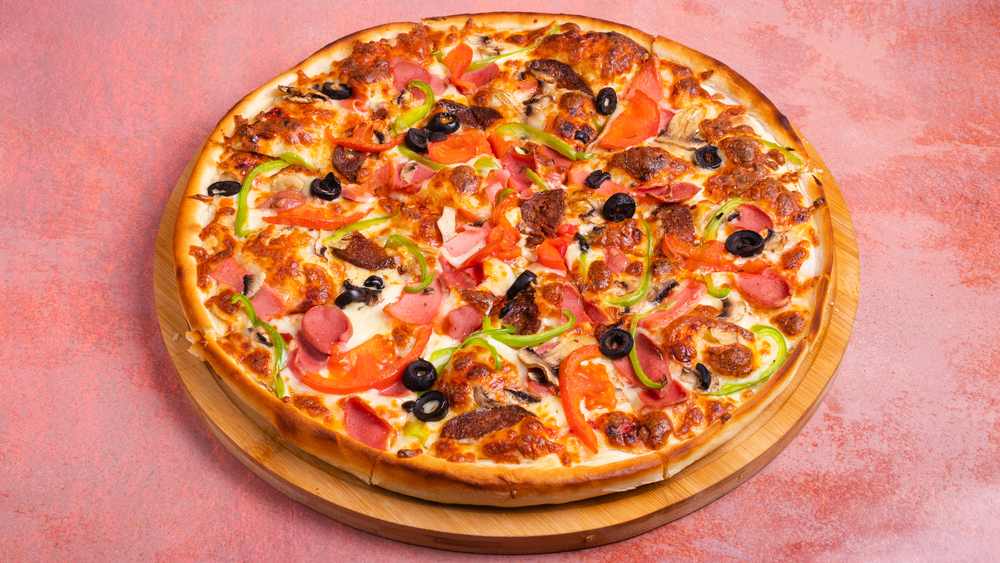 Mixed,Pizza,Isolated,On,Pink,Table,Closeup.