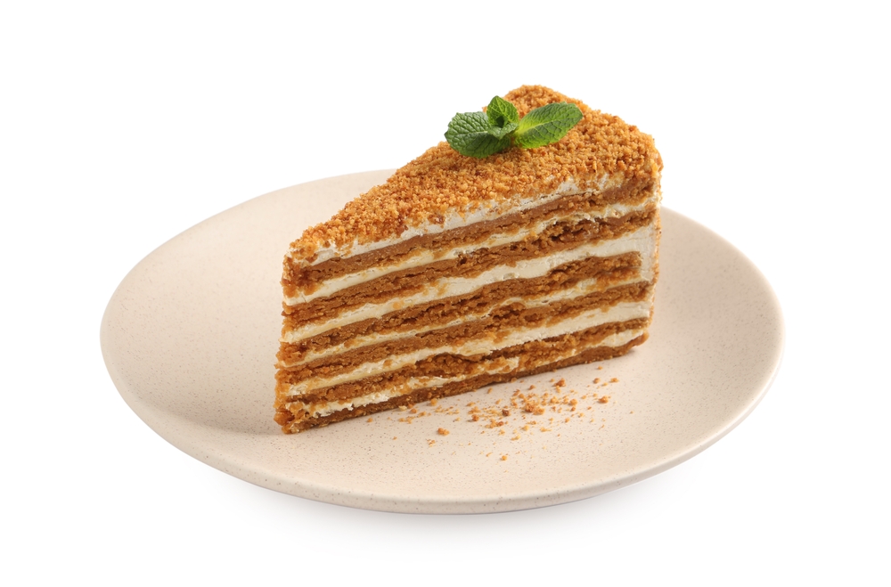 Slice,Of,Delicious,Layered,Honey,Cake,With,Mint,Isolated,On